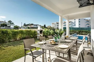 a table and chairs on the patio of a house at Silva by Algarve Villa Holidays in Albufeira