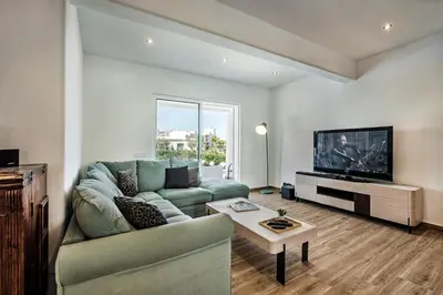 a living room with a couch and a tv at Silva by Algarve Villa Holidays in Albufeira