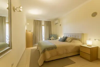 a bedroom with a bed and a window at Millennium Plaza in Vilamoura