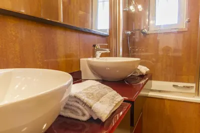a bathroom with a sink and a mirror and a sink at Millennium Plaza in Vilamoura