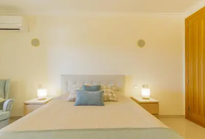 a bedroom with a large bed with two lamps at Millennium Plaza in Vilamoura