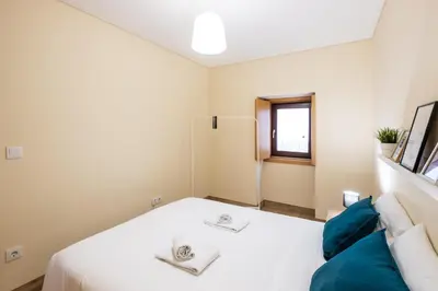 a white building with a brown door and three windows at #073 V3 Casa Verde by Home Holidays in Albufeira
