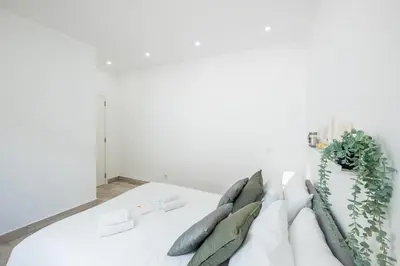 a pile of pillows sitting on top of a couch at #074 Casa dos Arcos by Home Holidays in Albufeira