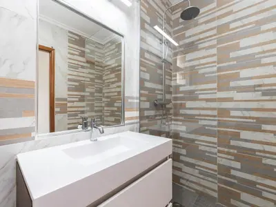 a bathroom with a white sink and a mirror at Akisol Albufeira Water in Albufeira