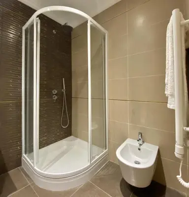 a bathroom with a shower and a toilet and a sink at Ténis Studio Apartment - Vilamoura in Vilamoura