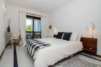a living room with a couch and a ottoman at Apartment Salgados Lounge - By Dalma Portuguesa in Albufeira