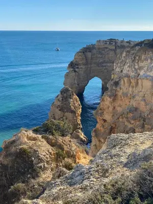 an arch in the rocks near the ocean at Casa Sophie Albufeira in Albufeira