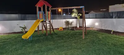 a yard with a playground on the side of a house at Sunrise Villa by Laranjal Rentals in Albufeira