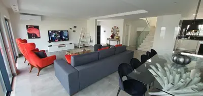 a living room with a blue couch and red chairs at Sunrise Villa by Laranjal Rentals in Albufeira