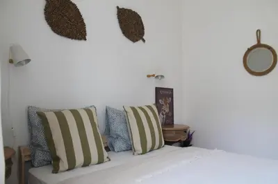a white couch with pillows on it in a room at Ti Maria Guest House in Faro