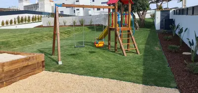 a playground with a slide in a yard at Sky Villa by Laranjal Rentals in Albufeira