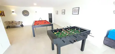 a ping pong table in a living room with a foos ball at Sky Villa by Laranjal Rentals in Albufeira