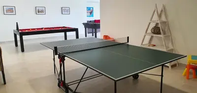 a ping pong table in a room with a ping pong racket at Sky Villa by Laranjal Rentals in Albufeira