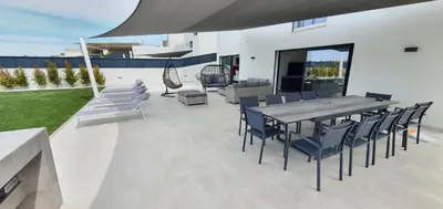 a patio with a wooden table and chairs at Sky Villa by Laranjal Rentals in Albufeira