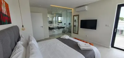 a bedroom with a large bed and a tv at Sky Villa by Laranjal Rentals in Albufeira