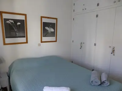 a bedroom with a blue bed and white cabinets at Apartment Marina in Albufeira