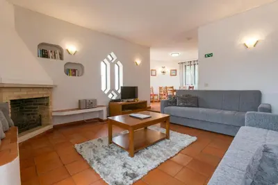 a living room with a couch and a fireplace at Villa Coelho in Albufeira