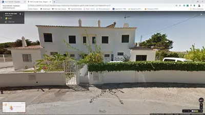 a white house with a white fence in front of it at Villa Coelho in Albufeira