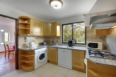 a kitchen with a washer and dryer in it at Villa Coelho in Albufeira