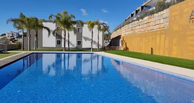 a swimming pool in front of a building at Alvorada Premium by Sunny Deluxe in Albufeira
