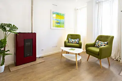 a living room with two chairs and a table at Casa da Vila in Faro