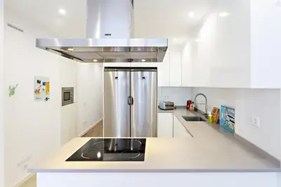 a kitchen with a sink and a stove top oven at Casa da Vila in Faro