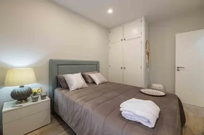 a bedroom with a large bed with pillows on it at Casa Santa Maria - Sea View - 500m from the Beach - WiFi in Albufeira