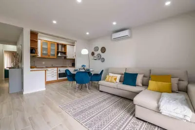 a living room with a couch and a table at Casa Santa Maria - Sea View - 500m from the Beach - WiFi in Albufeira