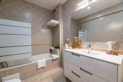 a bathroom with a sink and a tub and a toilet at Casa Santa Maria - Sea View - 500m from the Beach - WiFi in Albufeira