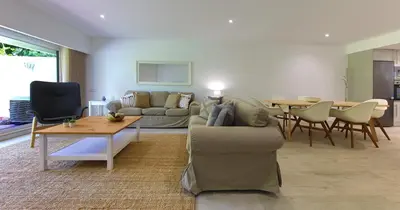 a living room with a couch and a table at Victory Village 20B in Quinta do Lago