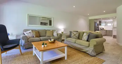 a living room with two couches and a table at Victory Village 20B in Quinta do Lago