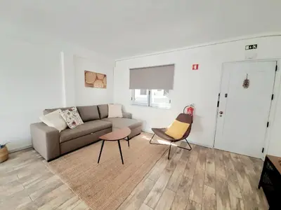 a living room with a couch and two chairs at Apartamento Patrick by Sunnyway in Albufeira