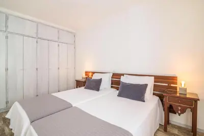 a bedroom with two beds and a side table at Apartamento Patrick by Sunnyway in Albufeira