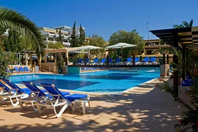 a swimming pool with blue chairs and a swimming pool at Apartamento Patrick by Sunnyway in Albufeira