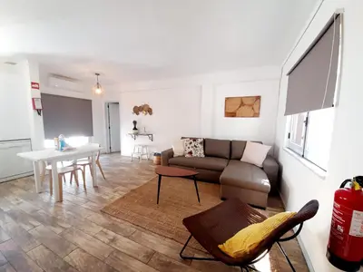 a living room with a couch and a table at Apartamento Patrick by Sunnyway in Albufeira