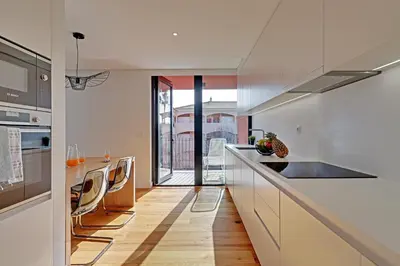 a kitchen with white cabinets and a counter top at Dubai Apartment in Vilamoura