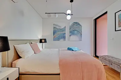 a bedroom with a bed and a couch at Dubai Apartment in Vilamoura