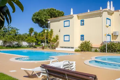 a villa with a swimming pool in front of a building at ALFELI-AP in Olhos de Água