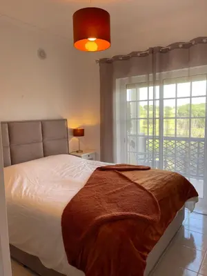 a bedroom with a bed and a large window at ALFELI-AP in Olhos de Água