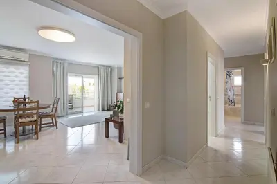 a dining room and living room with a dining table at Vilamoura Apartment 3 bedroom in Vilamoura