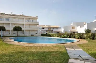 a swimming pool in front of a building at Vilamoura Apartment 3 bedroom in Vilamoura