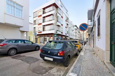 a group of cars parked on the side of a street at Casa Maria in Faro