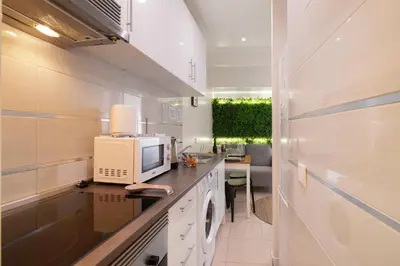 a kitchen with a desk with a computer on a counter at Casa Maria in Faro