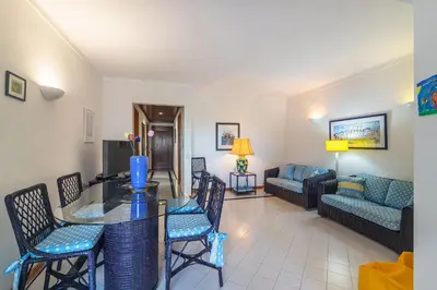 a living room with a table and chairs and a couch at Albufeira Salgados Beach 2 by Homing in Albufeira