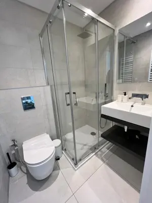 a bathroom with a shower and a toilet and a sink at Terraços Quarteira 2D3 in Quarteira