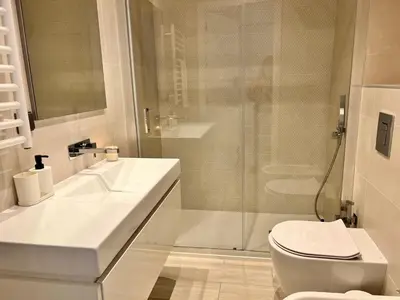 a bathroom with a sink and a toilet and a shower at Terraços Quarteira 2D3 in Quarteira