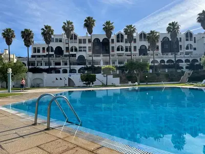 a large swimming pool in front of a large building at Title e Title - Oura Apartament Albufeira in Albufeira