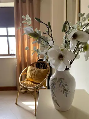 a bedroom with a bed and a chair and a window at Title e Title - Oura Apartament Albufeira in Albufeira