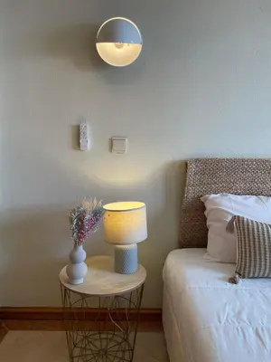 a bedroom with a bed with two lamps and two tables at Title e Title - Oura Apartament Albufeira in Albufeira