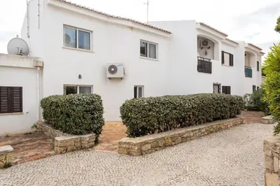 a white house with bushes in front of it at Townhouse Seraphina in Vale do Lobo